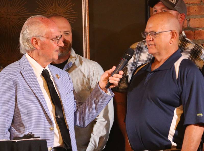 Dave Moore head coach of the 2005 Bureau Valley football team speaks with emcee Lanny Slevin during the Illinois Valley Sports Hall of Fame awards banquet on Thursday, June 6, 2024 at the Auditorium Ballroom in La Salle.