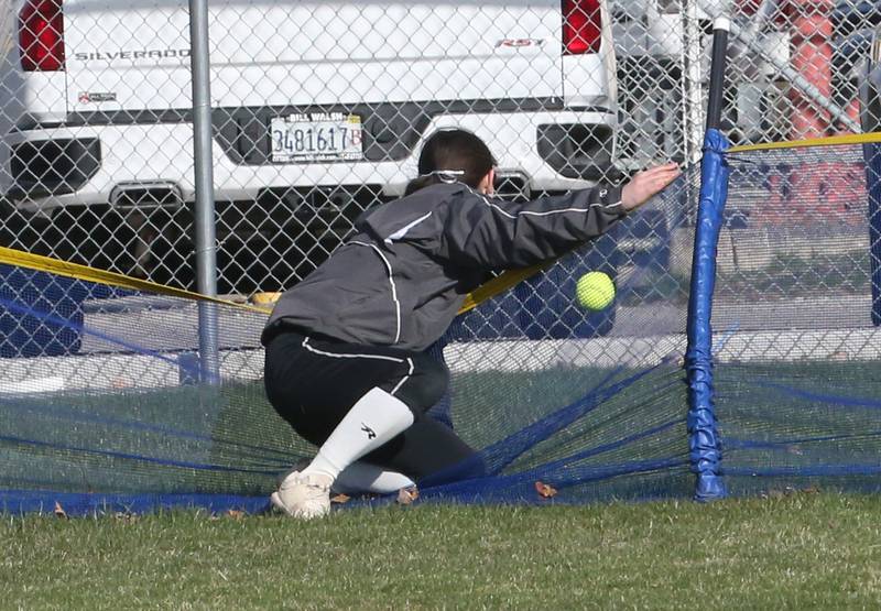 Woodland/Flanagan-Cornell center fielder Kaiden Connor gets tangled in the outfield fence after attempting to catch Marquette's Kealey Rick's homerun on Wednesday March 27, 2024 in Ottawa.