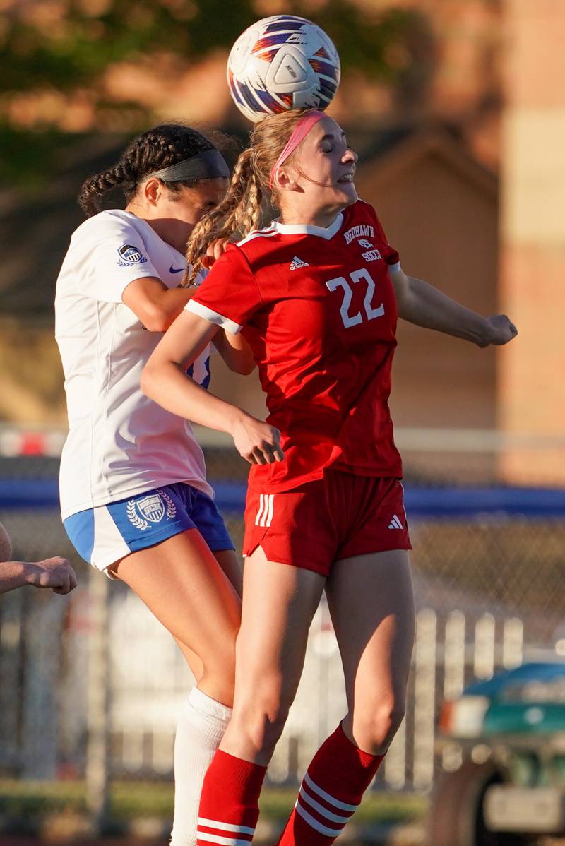Naperville Central's Nicole Sacek (22) goes up for a header against St. Charles North's Juliana Park (18) during a Class 3A St. Charles North Supersectional soccer final match at St. Charles North High School on Tuesday, May 28, 2024.