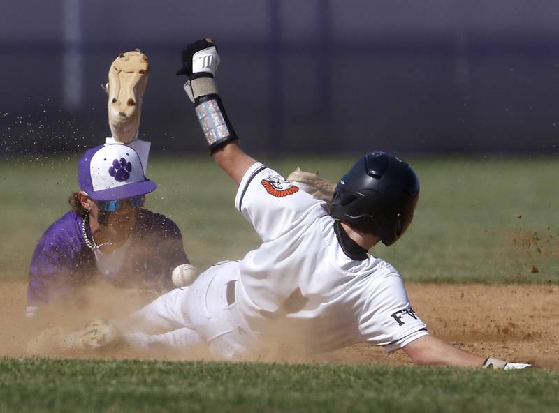 McHenry's Carson Weidner safely slides int second base as Hampshire's Calen Scheider tries to get him out during a Class 4A Hampshire sectional baseball game on Wednesday, May 29, 2024, at the Hampshire High School.