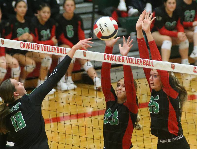 Geneseo's Kathryn VanDeWoestyne has her spike blocked by L-P's Kelsey Fredrick and teammate Aubrey Duttlinger in the Class 3A Regional on Tuesday, Oct. 24, 2023 at Sellett Gymnasium.