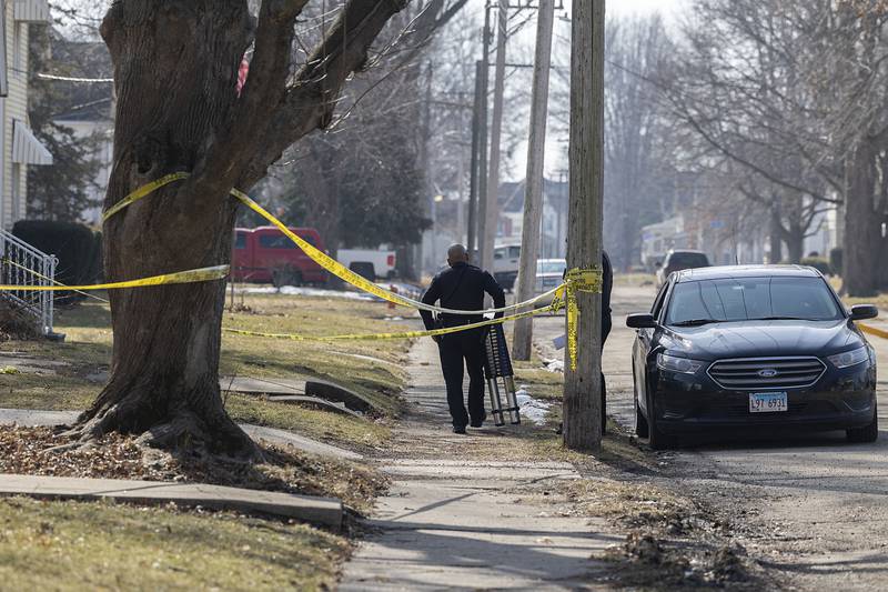 Investigators work at the scene Monday, Feb. 20, 2023 of a Sunday night shooting in the 1100 block of 4th Ave. in Sterling. One victim was pronounced dead with four taken into custody.