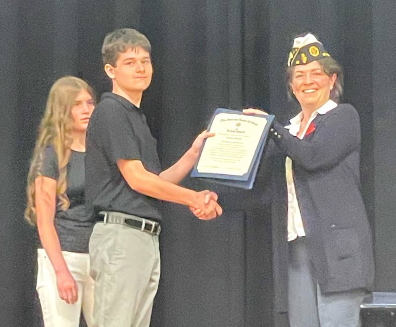 Commander Cynthia Reynolds presents Hurley Boothe with the American Legion School Medal Award.