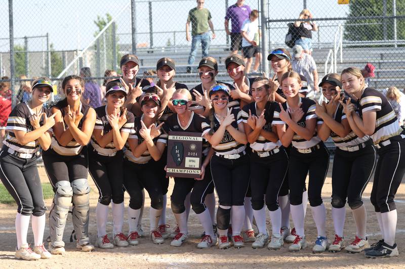 Sycamore players hold the Class 3A regional championship plaque after beating Dixon Thursday, May 23, 2024, at Rochelle High School.