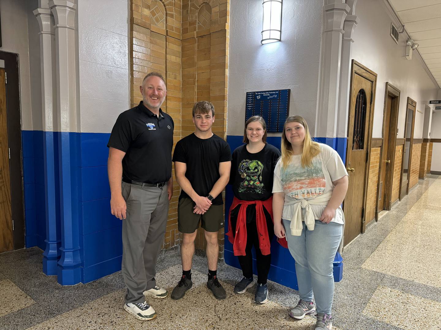 Pictured are members of the Princeton High School marketing class with Principal Andy Berlinski who elected to donate money to the EXTRA program. (From left) Mr. Berlinski, Izaiah Smallwood, Paige Fox and Olivia Fox pose for a photo.