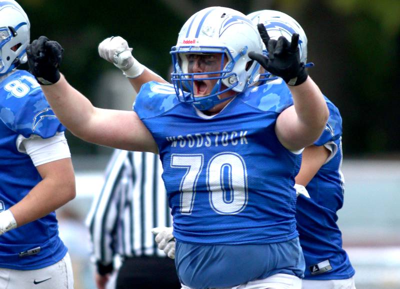 Woodstock’s Everett Flannery celebrates a Blue Streak win over Ottawa in varsity football at Larry Dale Field on the campus of Woodstock High School Saturday.