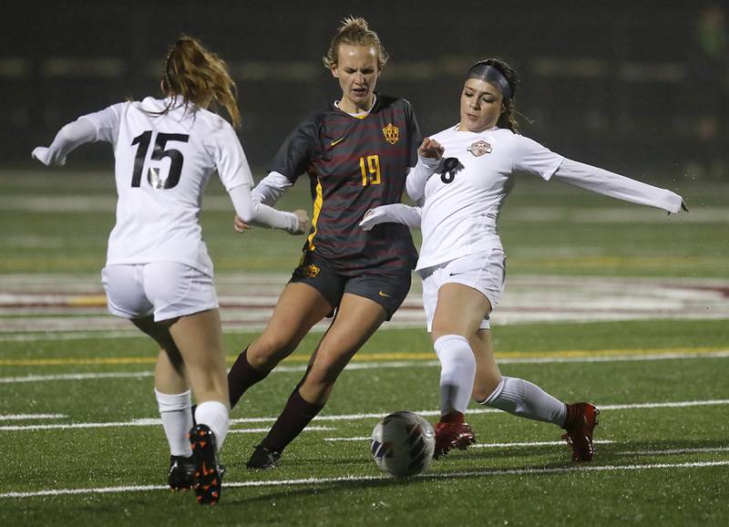 McHenry's Elena Carlos (right) kicks the ball away from Richmond-Burton's Rachel Mendlik and Mendlik tries to move between McHenry's Maya Gil and Carlos during a non-conference girls soccer match Thursday, March 16, 2023, at Richmond-Burton High. McHenry defeated Richmond Burton 4-0, in the first game of the season for both teams.