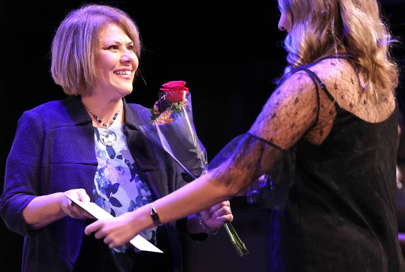 Athena Award finalist and eventual winner Michelle Bringas receives her gift for being a finalist Thursday, Oct. 19, 2023, during the Athena and Women of Accomplishment Awards reception hosted by the DeKalb Chamber of Commerce at the Egyptian Theatre.