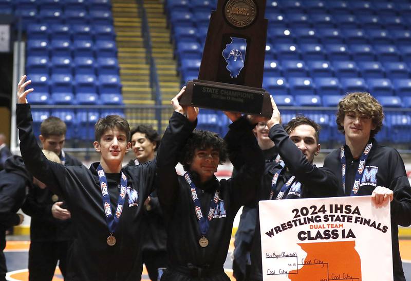 Wrestlers from Marina Central raise their first place trophy after defeating Coal City in the IHSA Class 1A Dual Team Sate Championship on Saturday, Feb. 24, 2024 at Grossinger Motors Arena in Bloomington.