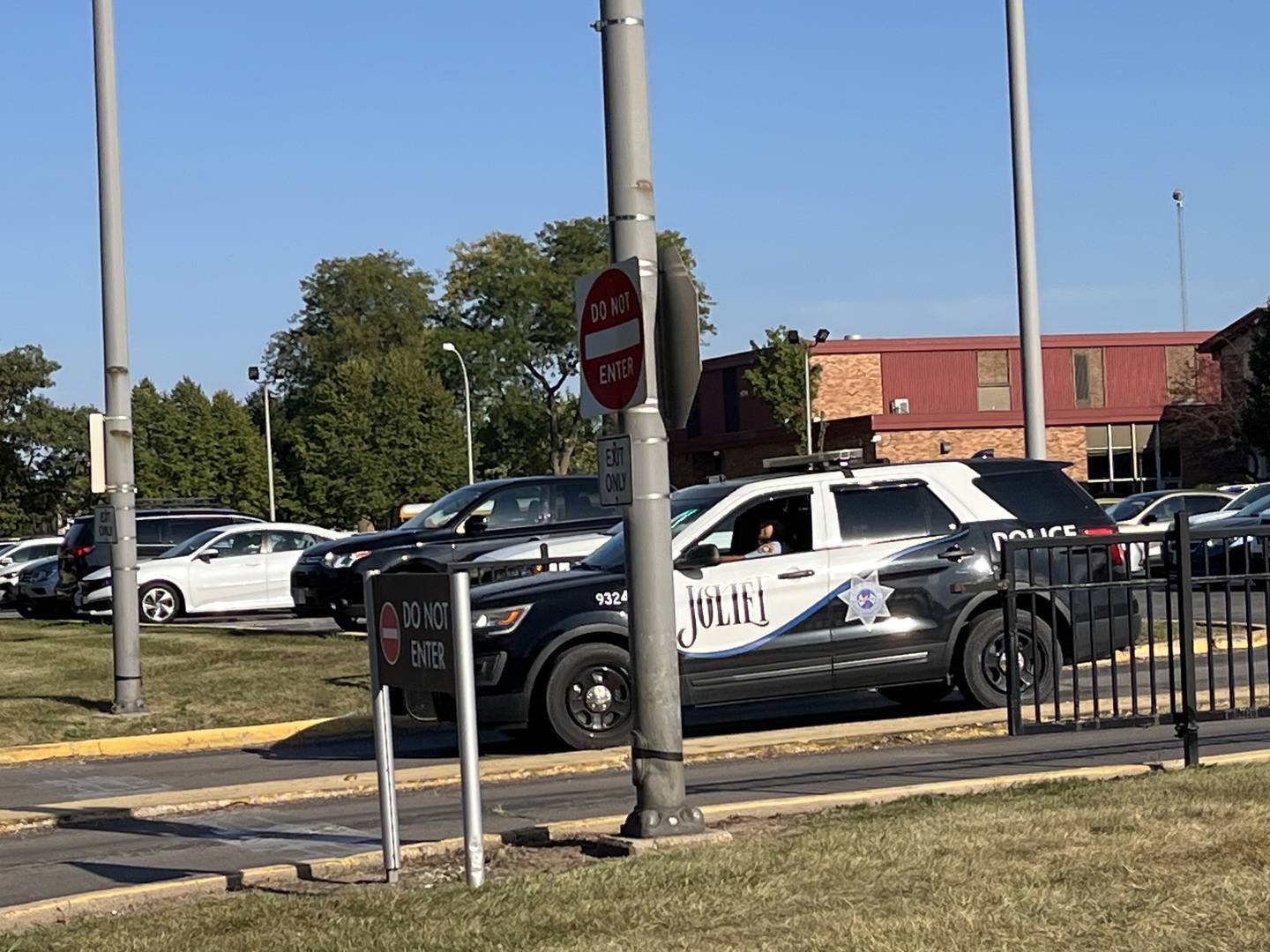 A Joliet police unit waits on the Joliet West High School campus as students are dismissed after the school was place on a safety protocol for several hours Friday, Sept. 13, 2024.  Police searched the campus after rumors of a weapon being at the school.