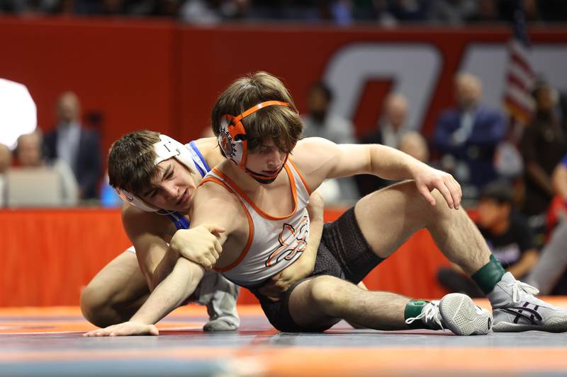 Marmion’s Nicholas Garcia wraps up St. Charles East’s Dom Munaretto in the 113-pound Class 3A state championship match on Saturday, Feb. 17th, 2024 in Champaign.