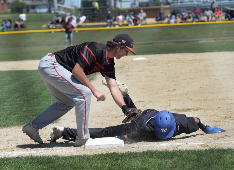 Forreston first baseman Alec Schoonhoven reaches to tag an East Dubuque runner as he drives back to the base during the 1A sectional championship game with East Dubuque on Saturday, May 25, 2024 at Forreston High School.