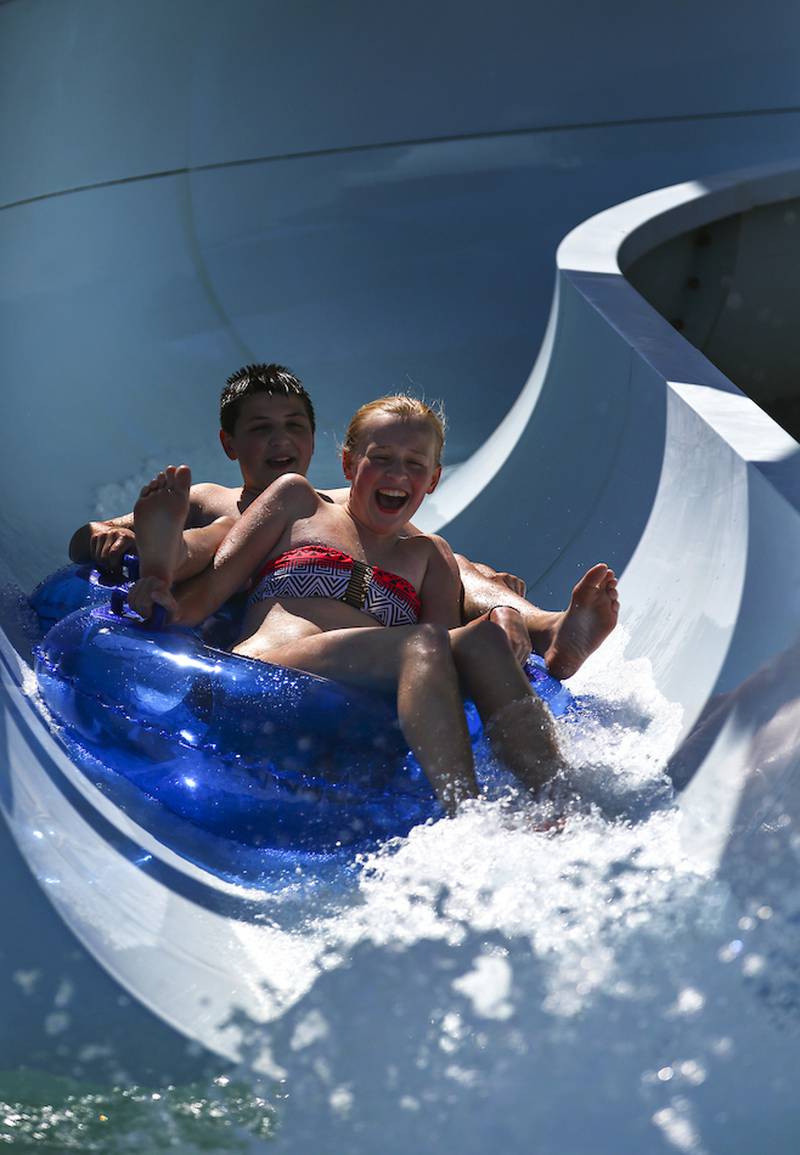 Nick Doran, 13, and Ellie Ruettiger, 14, slide down one of the many water slides at Splash Station Water Park in Joliet on Friday.