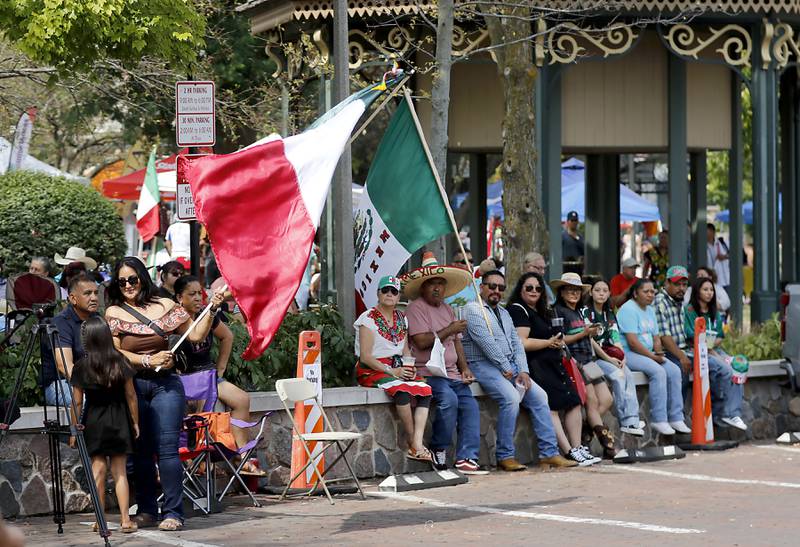 People listen to music of Los Del 608 during the annual Hispanic Connections Mexican Independence Day Celebration on Sunday, Sept. 15, 2024, in the Historic Woodstock Square. The celebration featured music, food and culture.