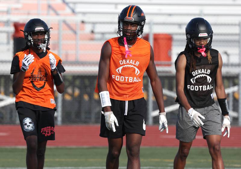 Some of the DeKalb receiving corps walks onto the field Monday, Aug. 12, 2024, at the school during the first practice of the regular season.