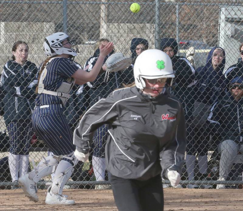 Marquette catcher Kelsey Cuchra makes a catch behind the plate to force out Woodland/Flanagan-Cornell's  Jaylei Leininger on Wednesday, March 27, 2024 in Ottawa.