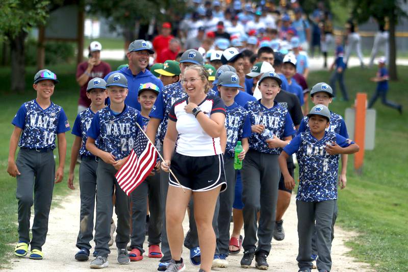 MCYSA intern Rachel Peat leads teams for an athlete parade during MCYSA 2023 Summer International Championships Opening Ceremonies Friday, July 14, 2023, at the Mickey Sund Complex in Lippold Park in Crystal Lake.