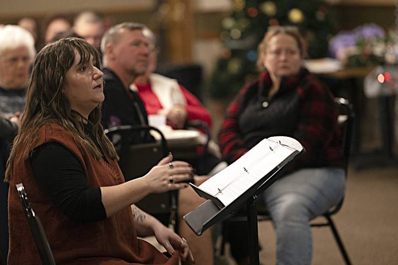 Choir director Erin Rogers leads her squad Thursday, Dec. 21, 2023 during the Madrigal dinner.