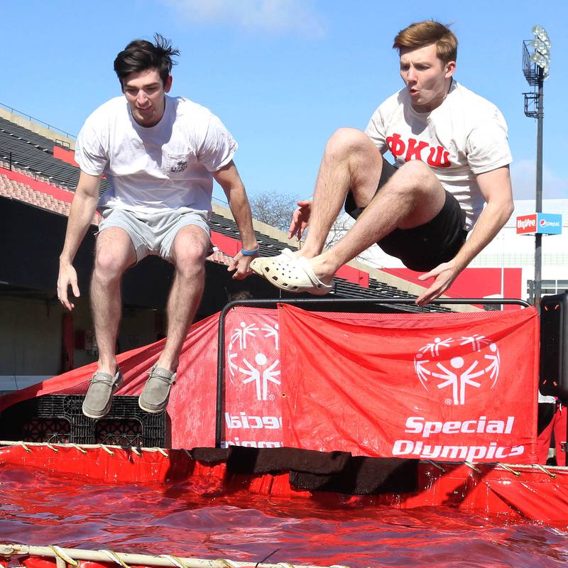 Members of the Phi Kappa Psi fraternity jump into the water on a cold and windy Saturday, Feb 17, 2024, during the Huskie Stadium Polar Plunge at Northern Illinois University in DeKalb. The Polar Plunge is the signature fundraiser for Special Olympics Illinois.