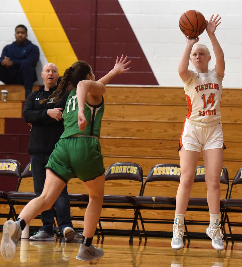 St. Charles East’s Addie Schlib hits a three pointer as Yorks’ Mia Barton gets a hand up on defense during the semifinal of the Montini girls basketball tournament Thursday December 28, 2023 in Lombard.