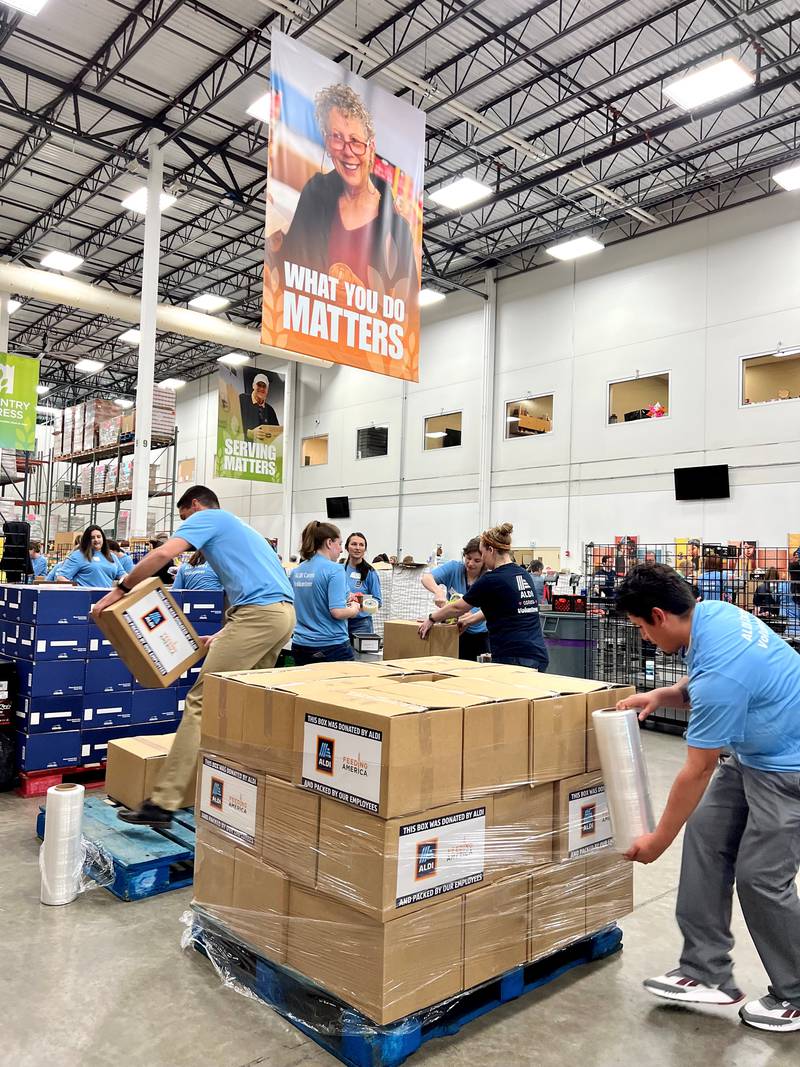 ALDI employees pack disaster relief boxes for Feeding America and the Northern Illinois Food Bank in Geneva, Illinois on May 9, 2023. Photo Credit: ALDI