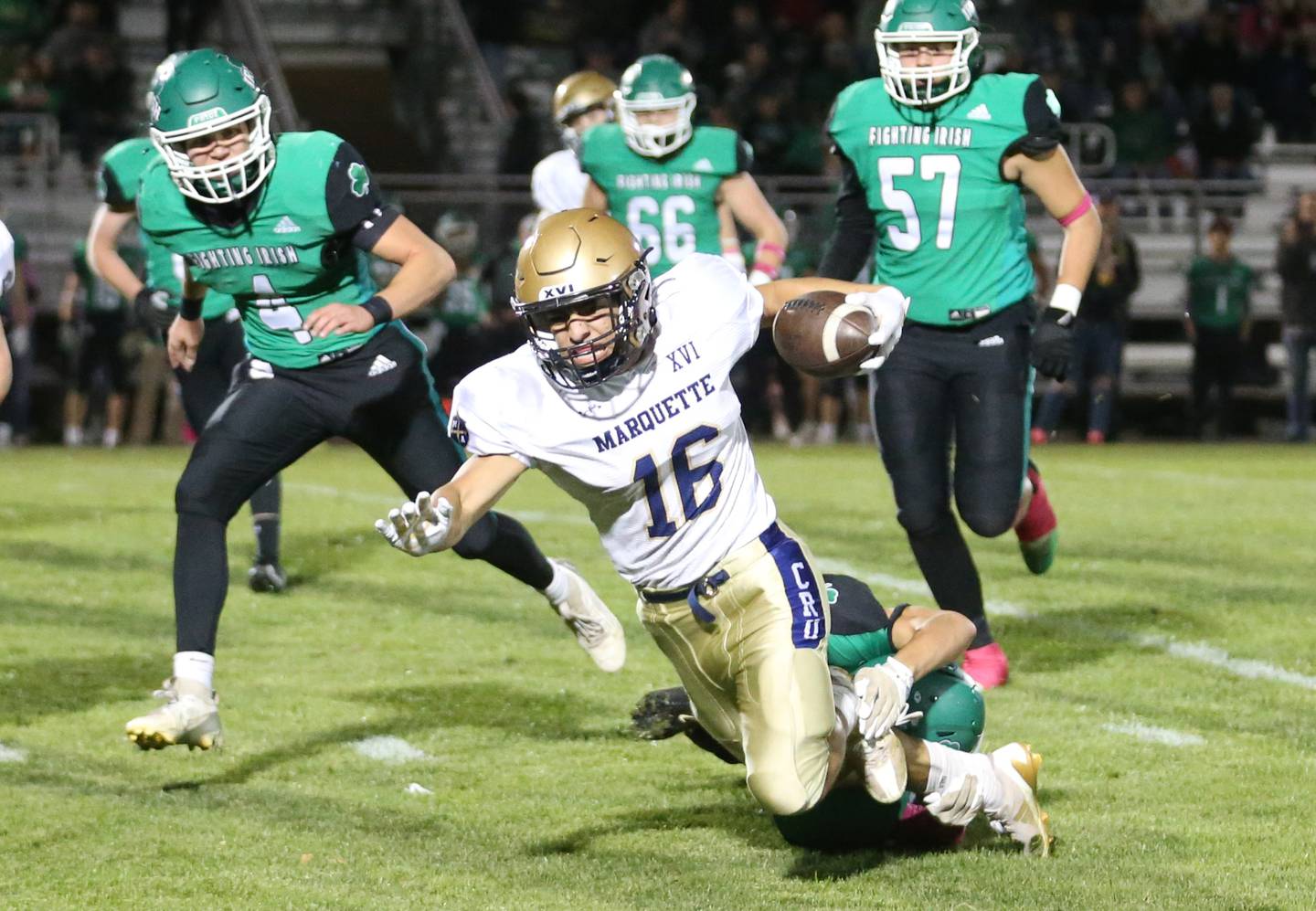 Marquette's Payton Gutierrez is brought down by Seneca defenders on Friday, Oct. 18, 2024 at Seneca High School.