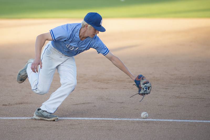 Columbia’s Lucas Riebeling can’t come up with a hot smash at third base against Joliet Catholic Friday, June 3, 2022 during the IHSA Class 2A baseball state semifinal.