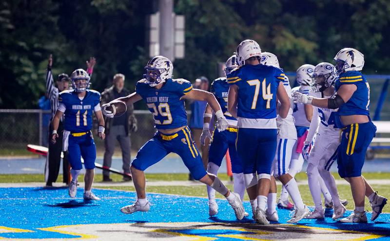 Wheaton North's Walker Owens (29) reacts after scoring a touchdown against Geneva during a football game at Wheaton North High School on Friday, Oct. 6, 2023.