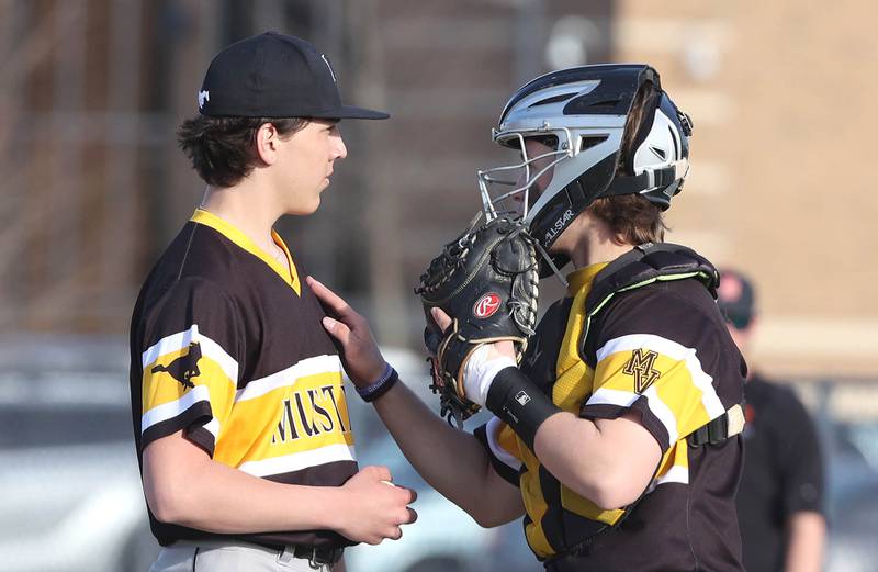 Metea Valley catcher Jake LaVine comes out to talk to pitcher Anthony Tardiff during their game Thursday, April 13, 2023, at DeKalb High School.