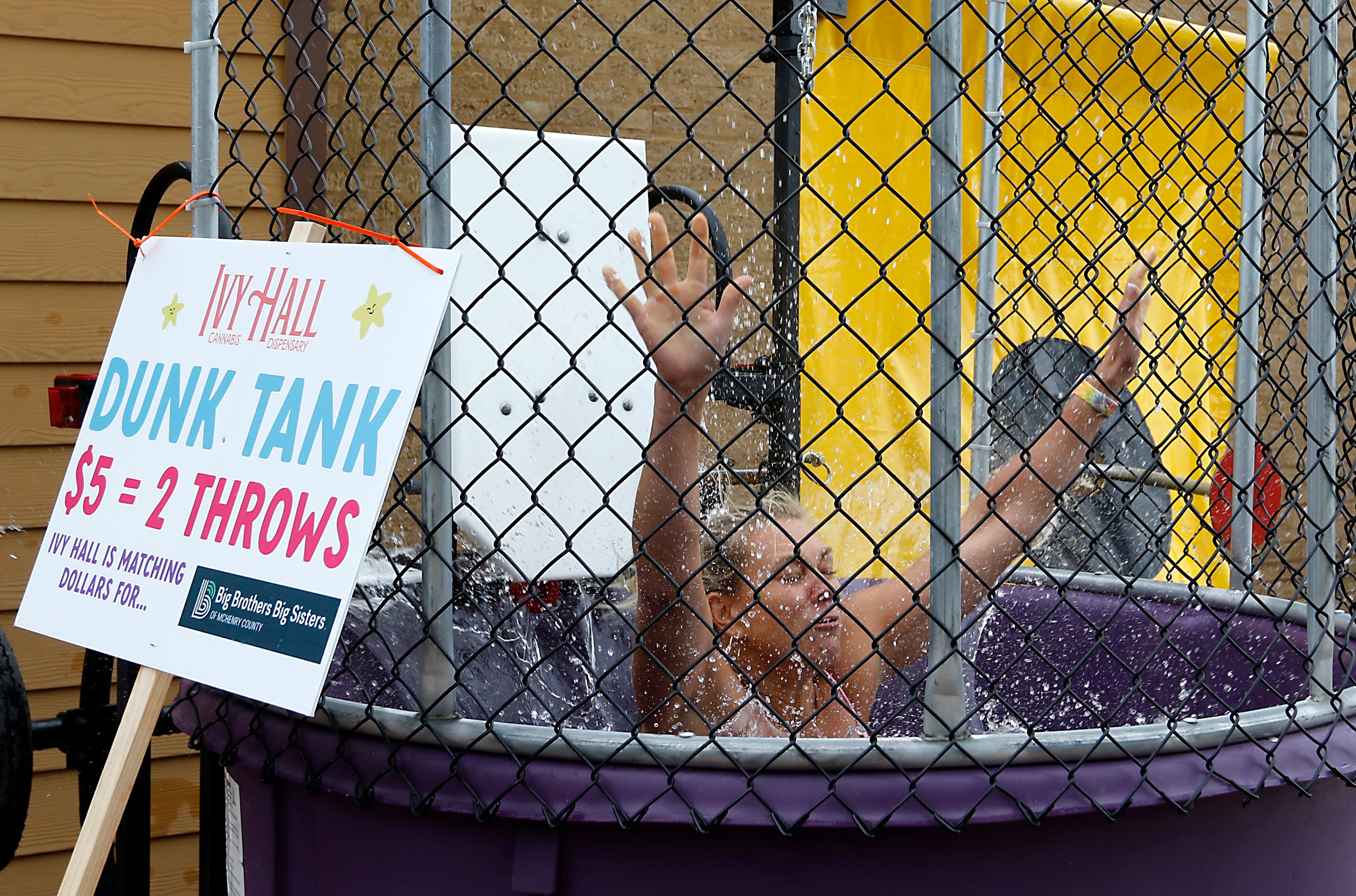 Miranda Alt hits the water while after being the dunk tank target during the Ice Cream Fest on Friday, Aug. 9, 2024, at Crystal Lake’s Main Beach.  The second annual event featured music, ice cream venders and an ice cream eating contest.