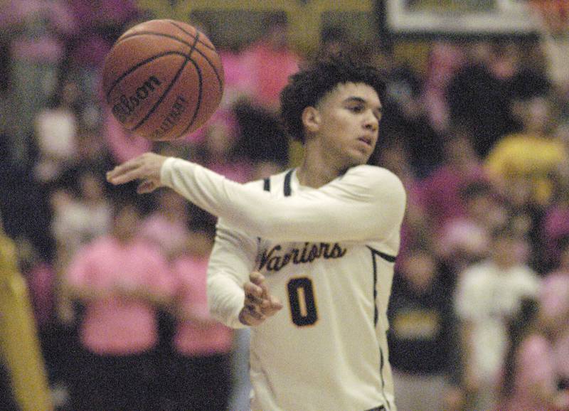 Sterling  player Andre  Klaver  dishes the ball off during their game againsy United Township Friday, Feb. 9, 2024 at Sterling High School