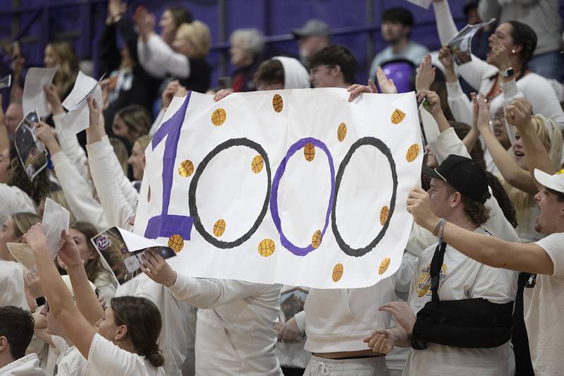 Dixon High School students hold a banner celebrating Darius Harrington’s 1,000 point of his basketball career Thursday, Feb. 15, 2024 at Dixon High School.