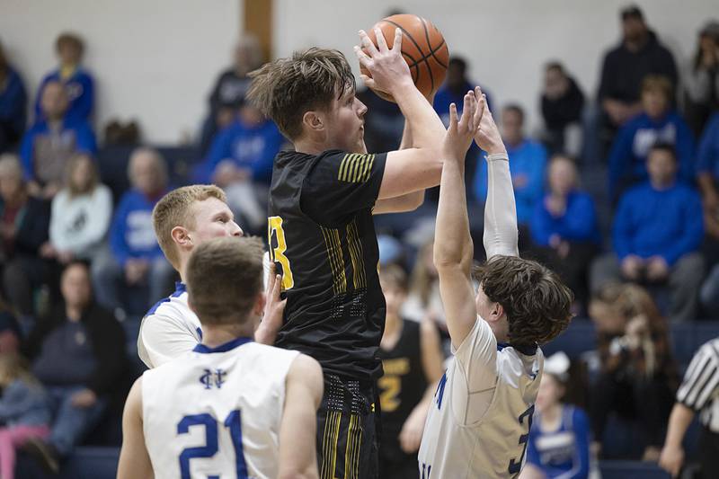 AFC’s Brock Lehman works below the basket against a trio of Newman Comets Monday, Feb. 19, 2024 in a regional quarterfinal game at Newman High School.