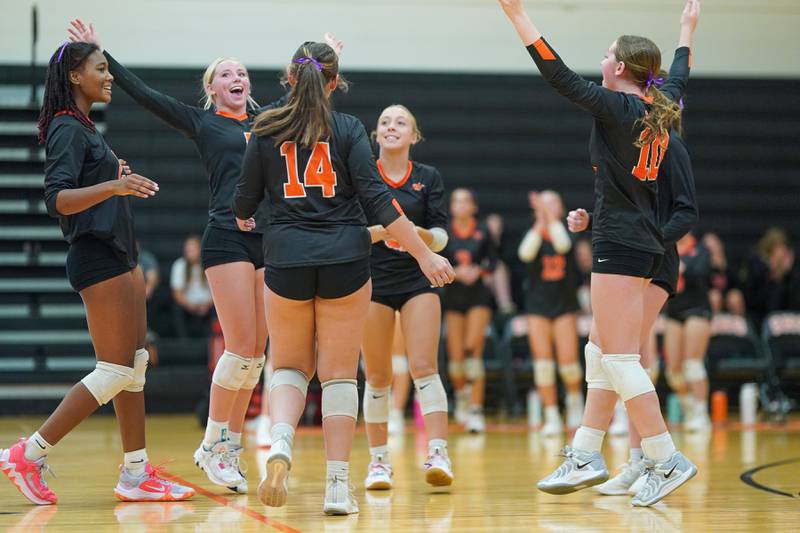 Sandwich players celebrate their two set victory over Plano during a volleyball match at Sandwich High School on Tuesday, Sep 10, 2024.