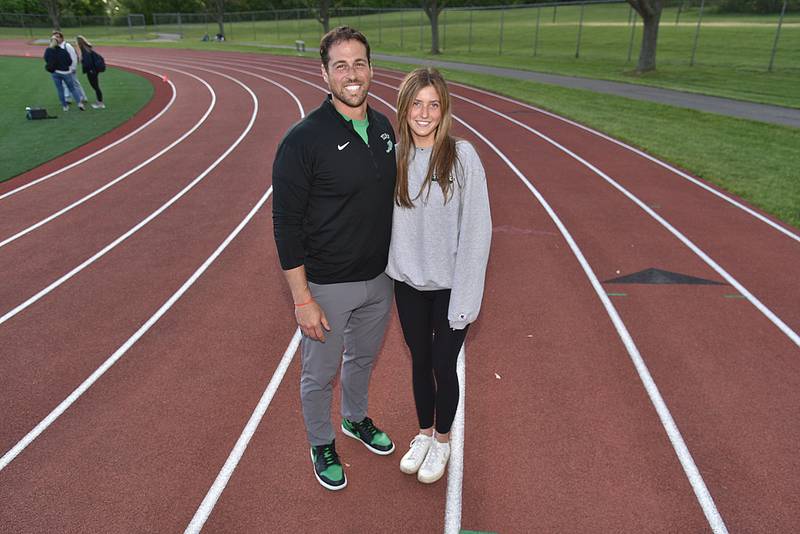 York High School assistant girls track coach Niko  Karavalos poses with athlete Chloe Peot on Friday, May 10, 2024.