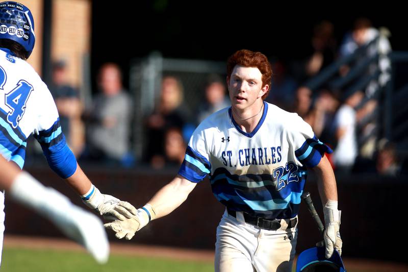 St. Charles North’s Jackson Spring is congratulated after scoring a run during a Class 4A St. Charles North Sectional semifinal game against South Elgin on Wednesday, May 29, 2024.