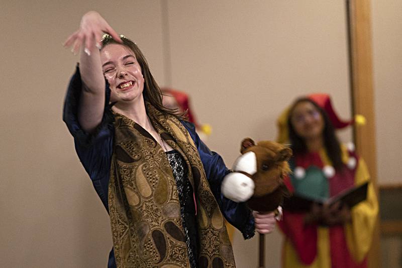 A Madrigal player acts out a scene Thursday, Dec. 21, 2023 during Dixon High School’s choir dinner.