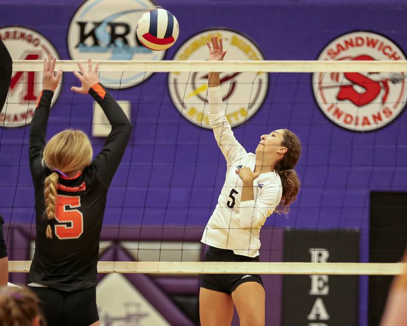 Plano's Alexa Sobieszczyk (5) tips the ball over the net during volleyball match between Sandwich at Plano.  Aug 21, 2023.