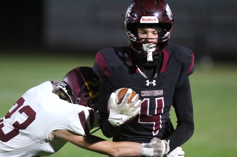 Marengo’s Parker Mandelky is tackled by Richmond Burton’s Caden Radmer in varsity football at Rod Poppe Field on the campus of Marengo High School in Marengo on Friday, Oct. 18, 2024.