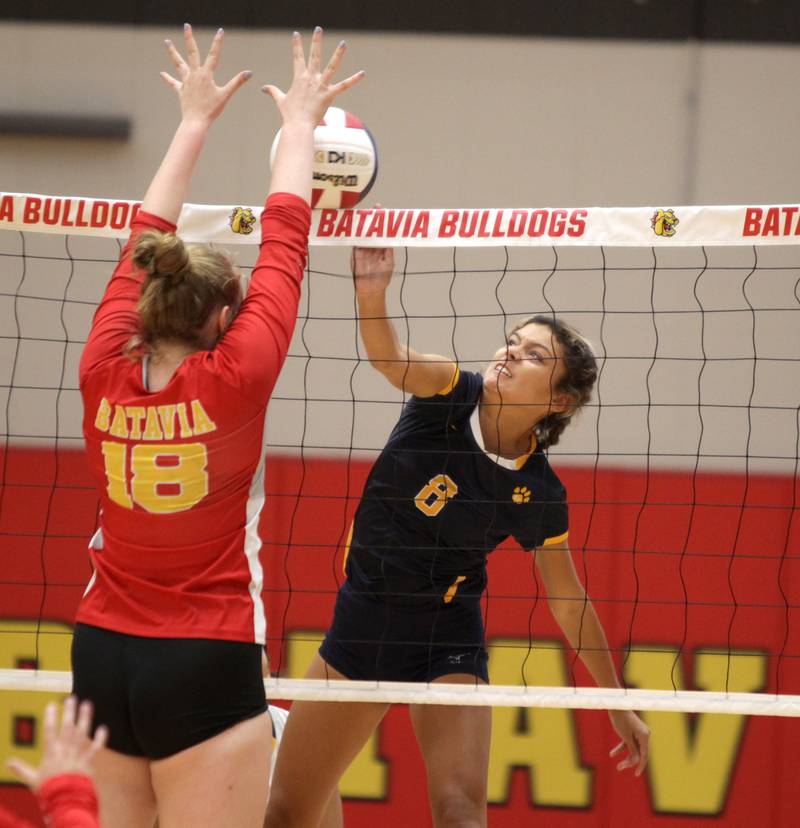 Neuqua Valley’s Isabelle Confessori (right) spikes the ball against a block from Batavia’s Brookelyn Vandeloo during a game at Batavia on Tuesday, Aug. 29, 2023.