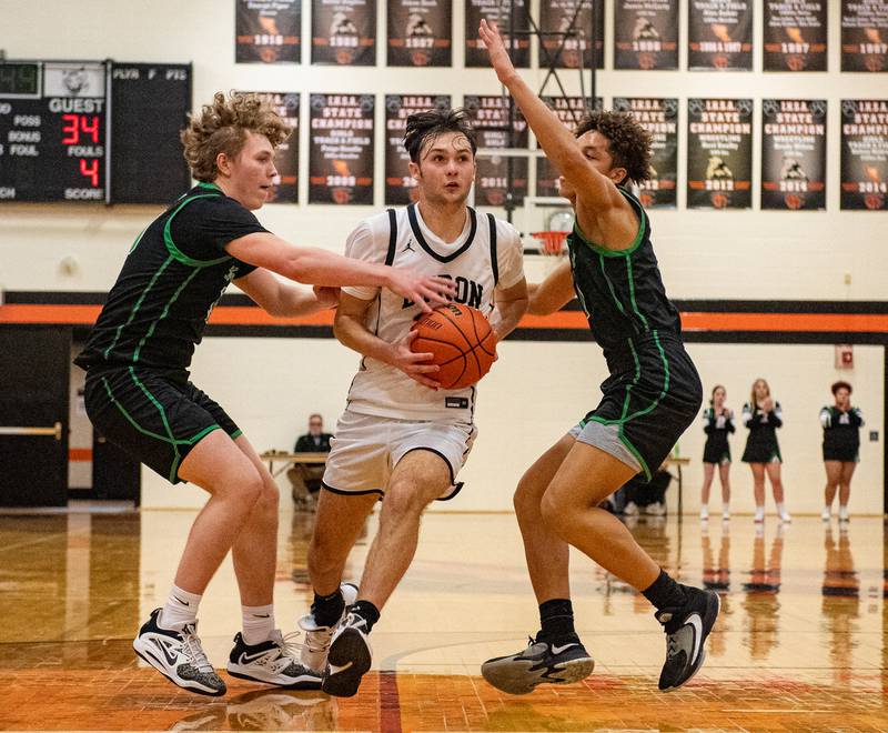 Rock Falls' Kuitim Heald (left) and Devin Tanton defend Byron's Nick Kesler during the fourth quarter of the 2A Byron Regional championship game on Saturday, Feb. 25, 2023.