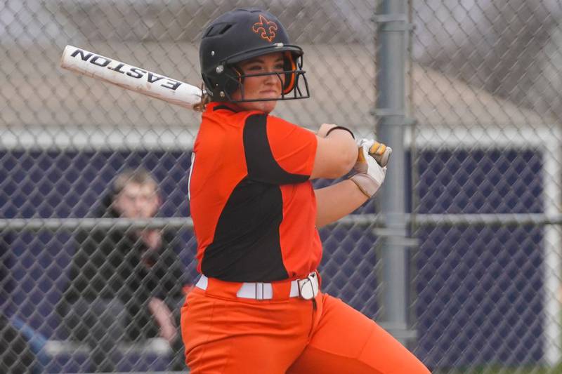 St. Charles East's Katie Morgan (10) singles driving in a run against Oswego East during a softball game at Oswego East High School on Wednesday, March 13, 2024.