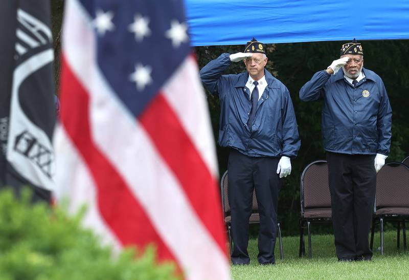 Members of the DeKalb American Legion Honor Guard salute the flag Monday, May 27, 2024, during the singing of “The Star-Spangled Banner” at the DeKalb Memorial Day program at Ellwood House.