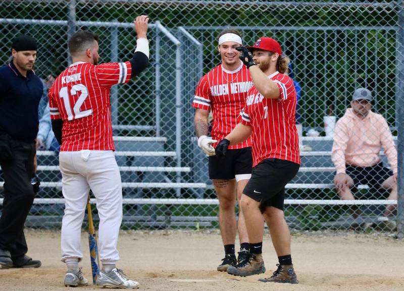 Jett Wedekind is welcomed home after hitting a three-run homer in the sixth inning to lift Malden Methodist to an 8-6 win in Tuesday's Princeton Park District Fastpitch League championship game opener against St. Matthews Tuesday night at Westside Park. Malden won the second game 15-5 to sweep the tournament championship.