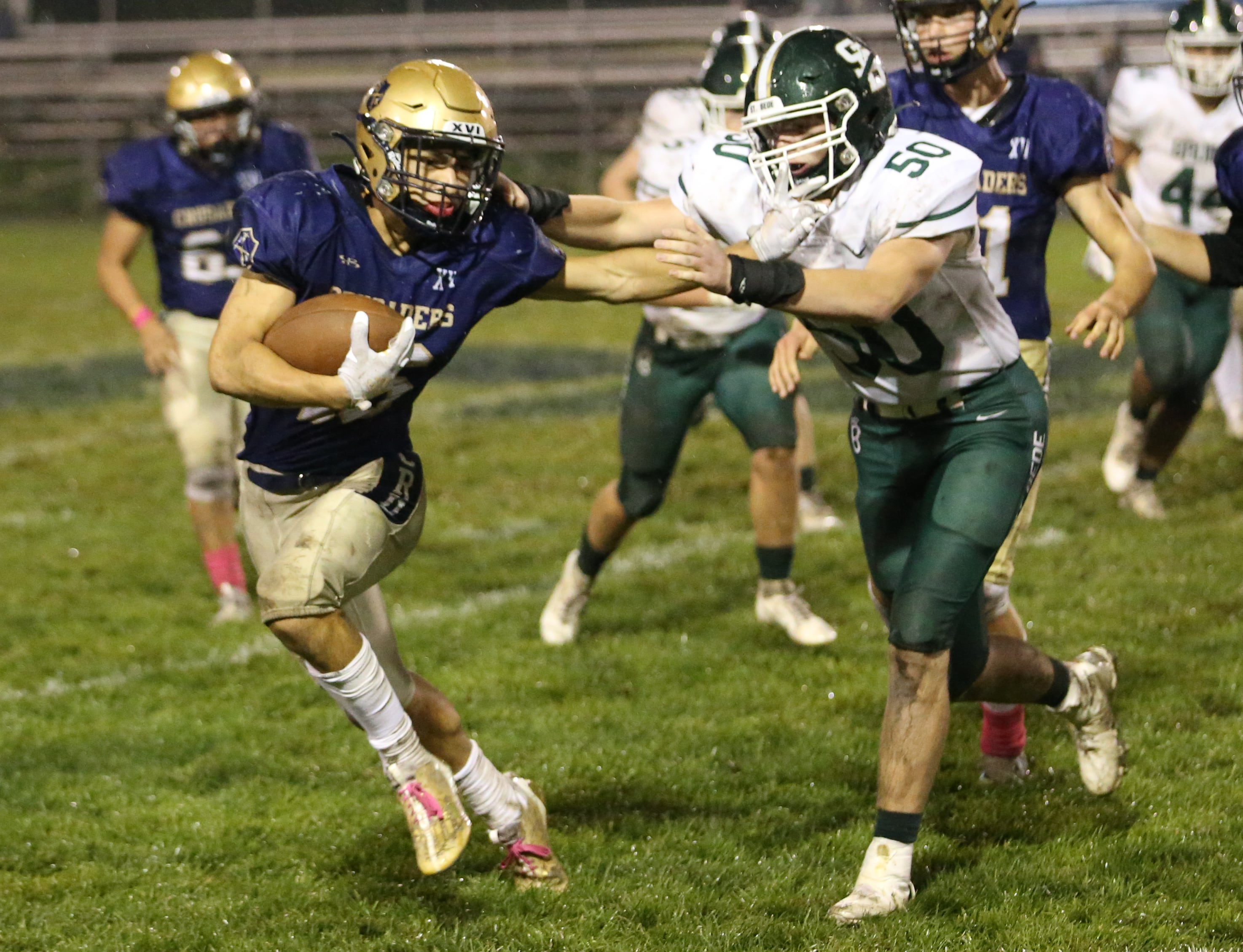 Marquette's Payton Gutierrez stiff-arms St. Bede's Jake Miglorini on Friday, Oct. 13, 2023, at Gould Stadium.