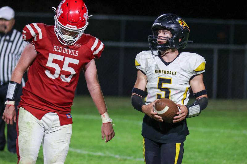 Kolton Kruse of Riverdale holds ball next to Jacob Mongan of Hall on Friday, October 18, 2024 at Richard Nesti Stadium in Spring Valley.