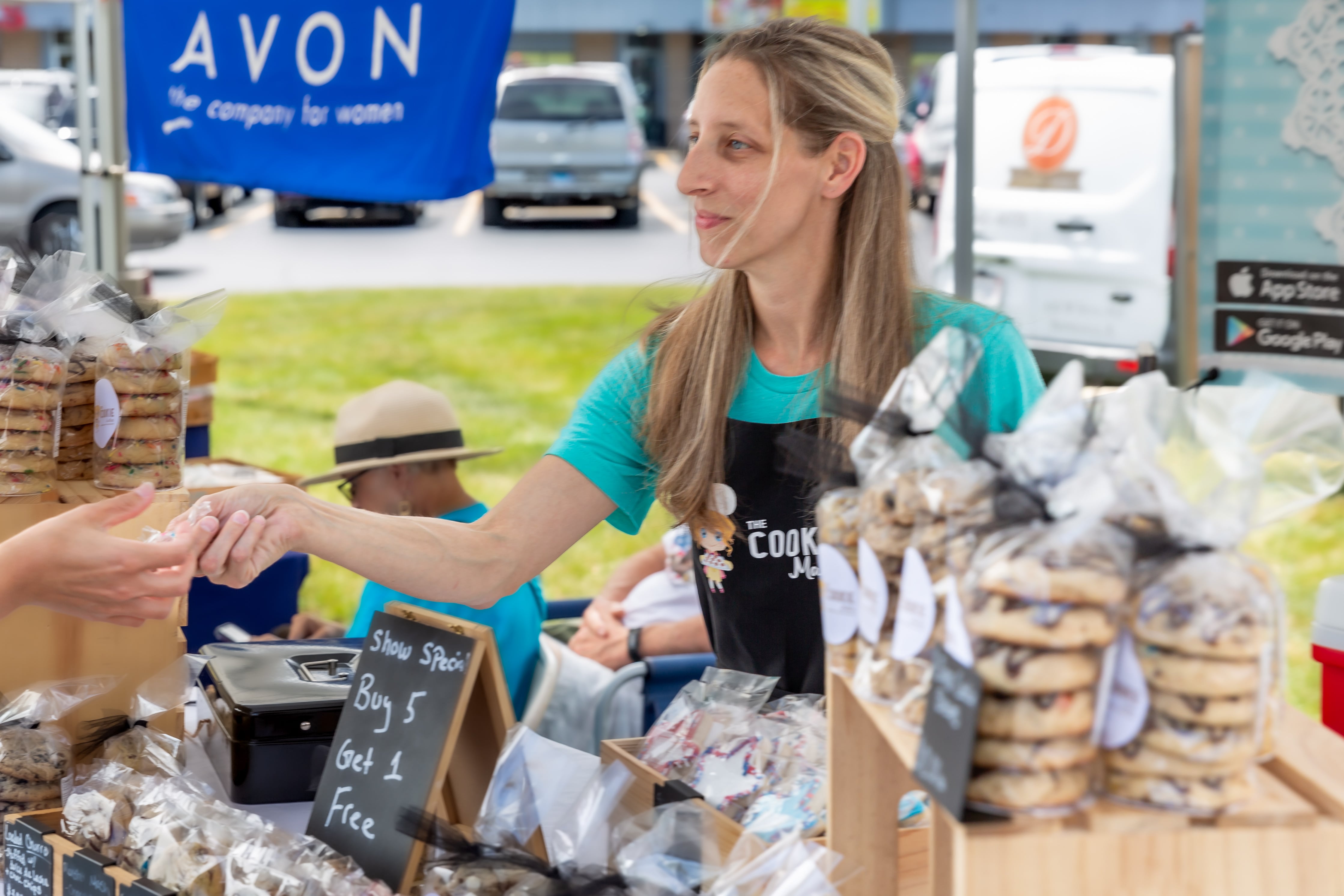 The Cookie Maker owner Heather Kratz hands out a cookie sample at the Winfield Farmer's Market in Winfield, IL.  July 3rd, 2024.