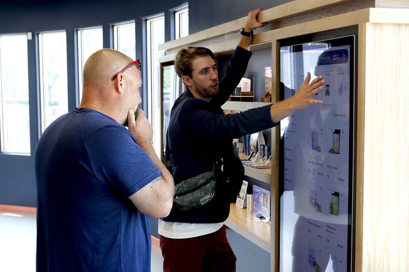 Smokehouse General Manager Zach Edgerton helps a customer at Illinois’ first dispensary located right on the water in Fox Lake on Friday, July 25, 2024. The dispensary located at 44 U.S. Route 12, features boat slips so customers on the Fox River and Chain O' Lakes can boat right up to the dispensary.