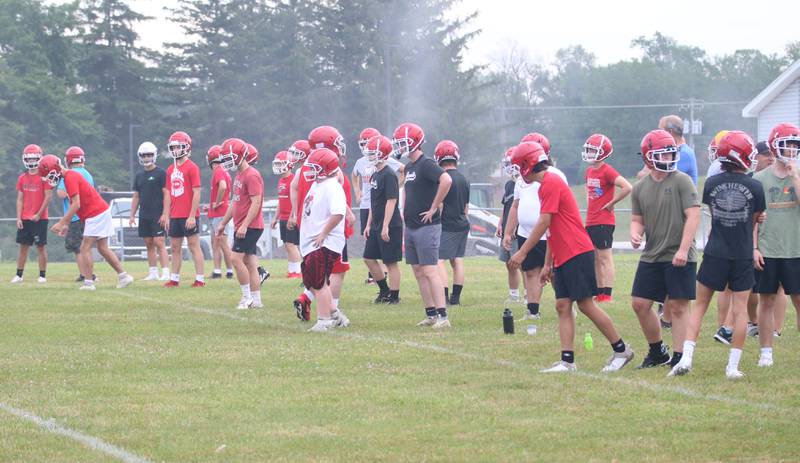 Hall football players warm up before practice on Tuesday, July 9, 2024 at Hall High School.