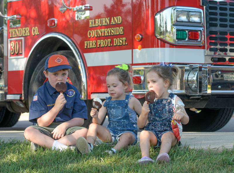 Peyton Masters, 6 and his twin sisters Maycee and Taylor, 3 of Wasco enjoy some ice cream in front of a fire truck during the Campton HillsÕ National Night Out on Tuesday, August 2, 2022.